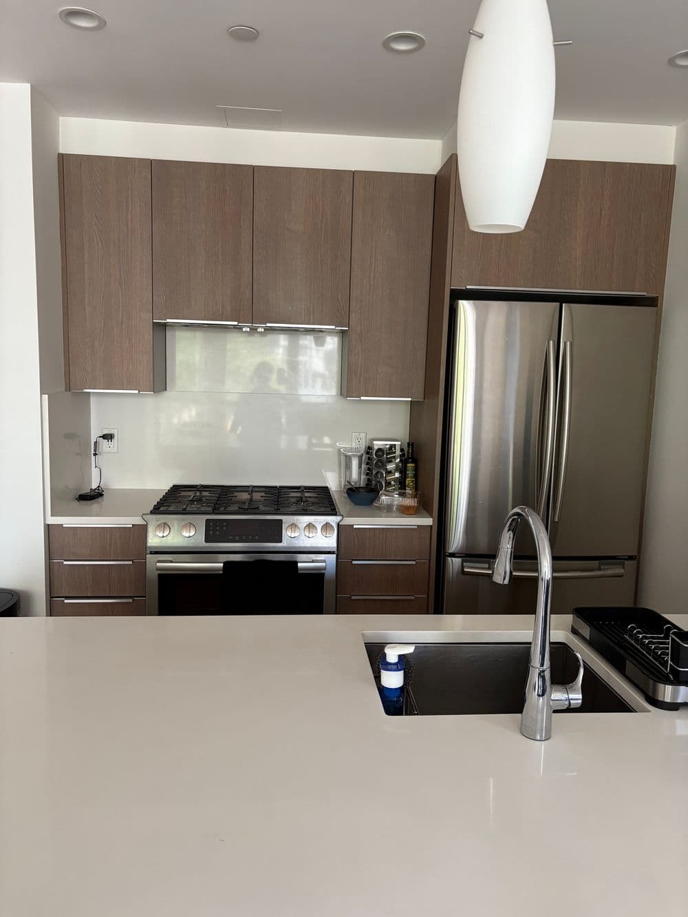 Modern kitchen featuring sleek cabinetry, stainless steel appliances, and a stylish island.