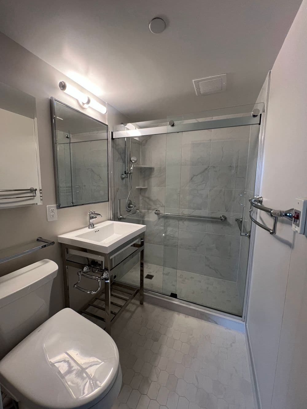 Contemporary bathroom with a glass shower, modern sink, and stylish fixtures.